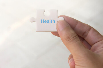 jigsaw puzzle in hand with message Health , healthcare relief concept