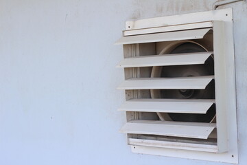 dirty industrial exhaust fan on wall