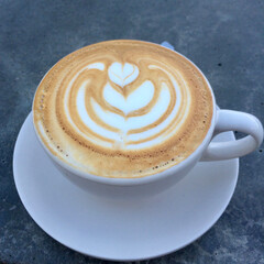 cup of cappuccino with flower