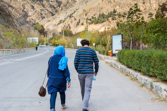 Iranian tourists walking at the the entrance to the Tochal complex in autumn, Tehran, Iran. Tochal is a popular recreational region for Tehran's residents