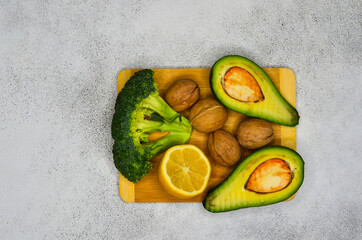 Banana, avocado, broccoli, lemon and inshell walnuts. The concept of proper nutrition and diet, detox and weight loss, vegetarian food and super food