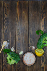 Broccoli, garlic, lemon slice and pink himalayan salt. Food background with copy space for text, ingredients for cooking