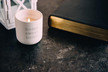 Bible on a table with a candle.