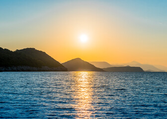 Naklejka na ściany i meble A view of mountains at sunset in the Adriatic sea near Mljet island, Chroatia