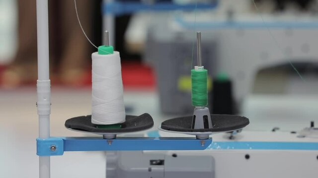 Roll of thread used in the sewing machine, different colored roll of thread.Manufacture industrial textile spinning. Textiles and Fabrics.