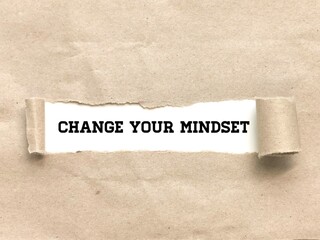 Phrase CHANGE YOUR MINDSET appearing behind torn brown paper.For background purpose.