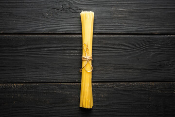 Dried spaghetti on rustic background. Shot from above. Selective focus.
