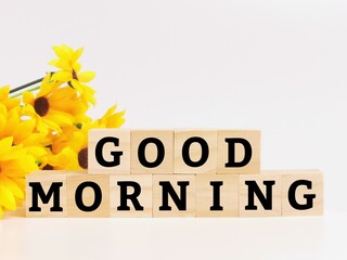 Text GOOD MORNING on wooden cubes isolated on white background.