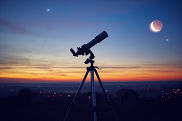 Silhouette of a astronomy telescope with twilight sky. © astrosystem