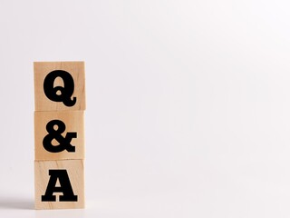 Text Q AND A on wooden cubes isolated on white background.Business concept.