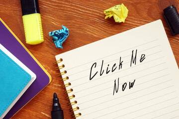 Conceptual photo about Click Me Now with handwritten phrase.