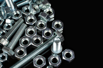 metal bolts and nuts group on black background