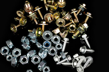 metal bolts and nuts group on black background