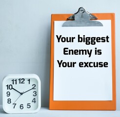 Motivational quote on clip board YOUR BIGGEST ENEMY IS YOUR EXCUSE.