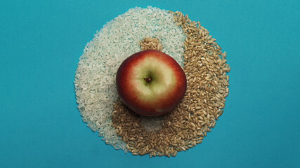 Light and dark rice. Yin and Yang symbol. On a turquoise background.