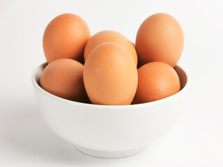 Chicken eggs in a bowl isolated on white background.