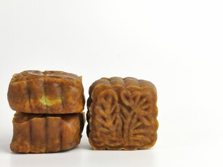 Selective focus photo with noise effect of square shape moon cake isolated on white background.