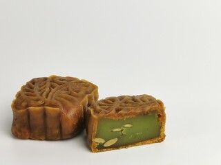 Selective focus photo with noise effect of square shape moon cake isolated on white background.