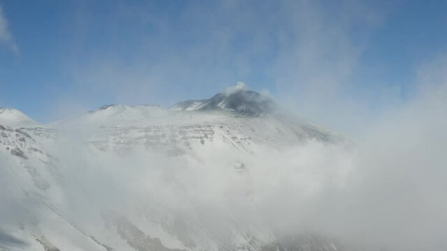 Etna with a view of the South East crater after a snowfall and the spectacular Valle del Bove with its dikes and solidified lava flows. Sicily. Italy.