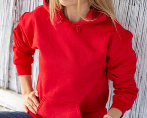 Unrecognizable blon woman wears red hoodie. Casual christmas outfit. Clothing design with copy space for mockup. - 401744016