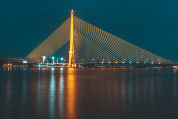 Nighttime at The Rama VIII or 8 Bridge is a cable-stayed bridge crossing the Chao Phraya River in Bangkok, Thailand. Asia.
