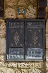 The background of old, beige wall with metallic, retro window