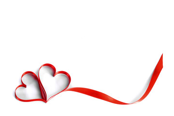 Heart shaped red ribbon on white