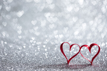 Red ribbon hearts on glitters