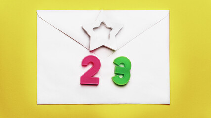 February 23 holiday background. 23 figure figurine made of plastic, a symbol of Russia. Men's Defender of the Fatherland Day.