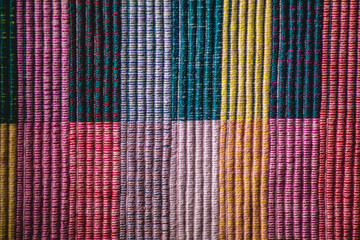 textured background  colored cotton threads squares