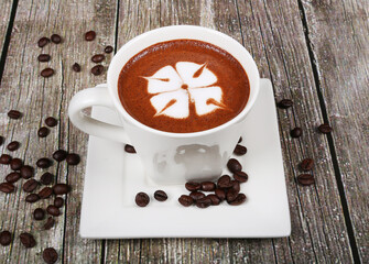 hot beverage coffee cappuccino white cup garnished with coffee beans 