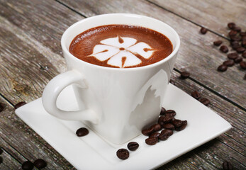 hot beverage coffee cappuccino white cup garnished with coffee beans 