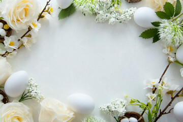 Fototapeta na wymiar Easter floral frame with white eggs, green leaves and cherry flowers. Flat lay with copy space