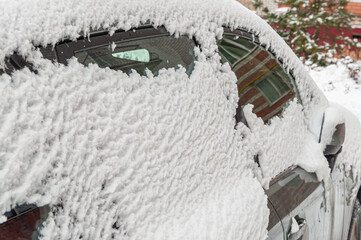 Close-up of snow-covered side Windows of a car