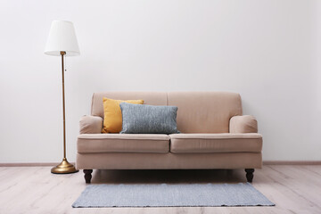 Simple room interior with comfortable beige sofa