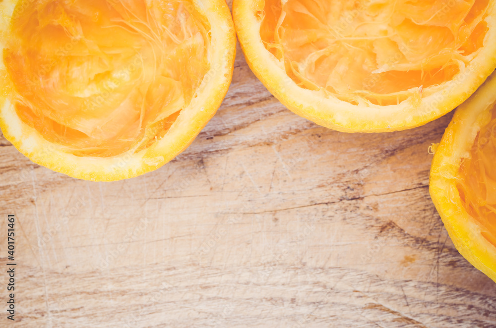Poster a top view of sliced empty oranges on a wooden board with copy space
