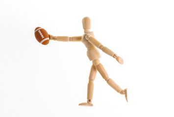 Wooden puppet dummy playing fugby isolated on white background