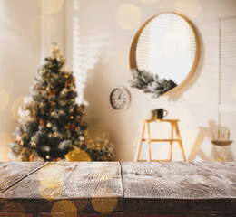 Empty wooden surface and blurred Christmas tree in room on background, bokeh effect. Space for design