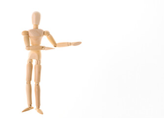 Wooden puppet mannequin shows on space for your text isolated on white background. Copy space