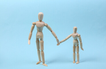 Parenthood. Two puppets hold hands on a blue background. Spending time with children