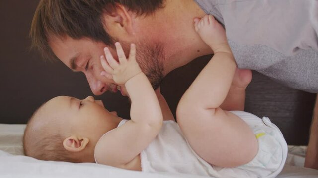 Happy family. Portrait of bearded father and newborn baby girl hugging. Paternity Parenthood happiness. Loving dad enjoying caring playing with little child. healthy childcare, love.