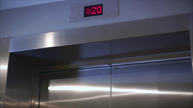 Metal doors smoothly open and close. Silver new elevator on the 1st floor 4k video. Opening the door is an elevator. The elevator doors open.