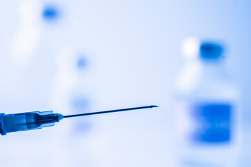 A single bottle vial of Covid-19 vaccine. Medical concept vaccination hypodermic injection...
