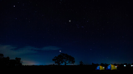 Panorama blue night sky milky way and stars. Set up a tent and stay overnight. For nature tourists