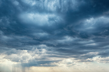 Deep blue rainy clouds and  some rays of light