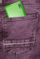 Green smartphone in back jeans pocket