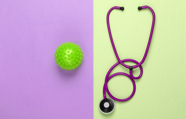 Fototapeta premium Diagnosis of coronavirus, pneumonia. Stethoscope with a strain of virus on pink green background