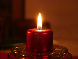 Close-up on a lit candle to make a prayer