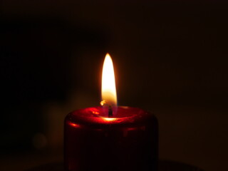 Close-up on a lit candle to make a prayer