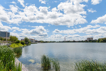 Fototapeta na wymiar KAZAN, RUSSIA - June, 2020. Lake Nizhny (Lower) Kaban embankment, reeds, grass in the water. Kazan, Tatarstan